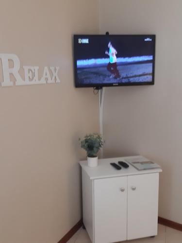 a flat screen tv on a wall in a room at On Yonder Hill in Cape Town