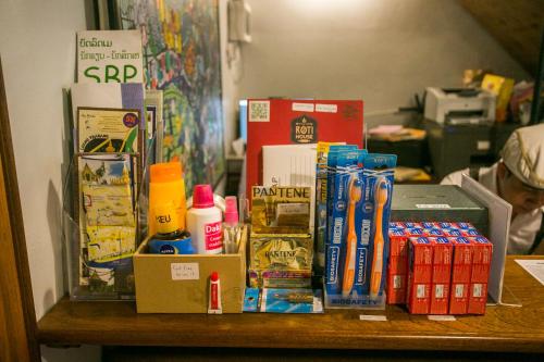 a table topped with boxes of food and drinks at Barn1920s Hostel in Vientiane