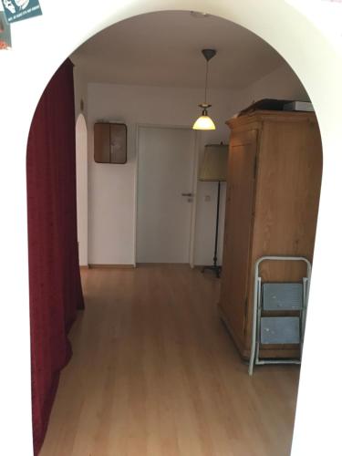 an archway leading into a living room with a table at Gästezimmer Süß- Scharf in Meckenbeuren