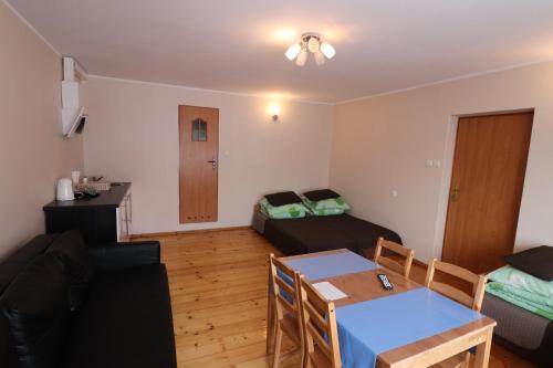a living room with a couch and a table at Gorce apartamenty i pokoje in Rabka-Zdrój