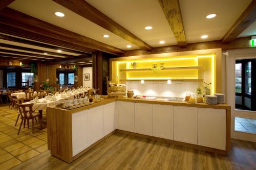 a restaurant with a dining room with a table at Landhotel Teuteberg in Bad Arolsen
