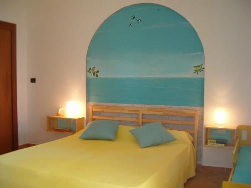 una camera da letto con un letto dipinto sull'oceano di Pietra Fiorita a Pisciotta