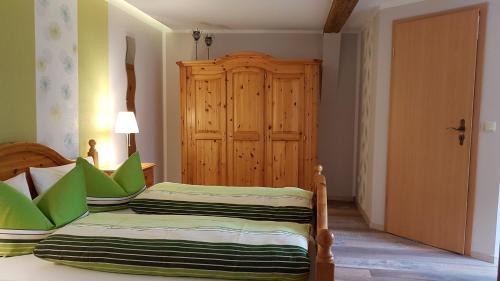 1 dormitorio con 2 camas y armario de madera en Gästezimmer Vockerodt, en Nottleben