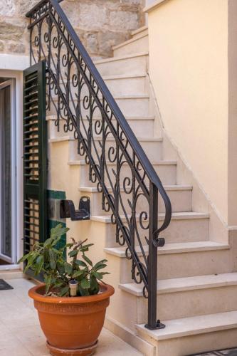 a staircase with a plant in a pot at Apartments and Rooms Villa Erede in Split