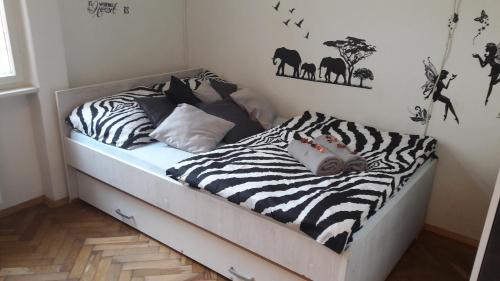 a bed in a room with zebras and elephants at Apartment Marko in Zagreb