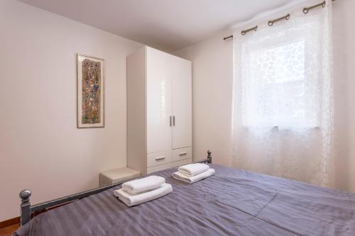 a bedroom with a bed with two white pillows on it at Apartments and Rooms Villa Erede in Split