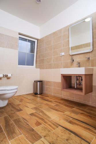 a bathroom with a toilet and a sink and a mirror at Penzion Lesni in Milovice