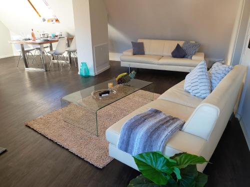 a living room with a couch and a table at Seeperle 4 in Meersburg