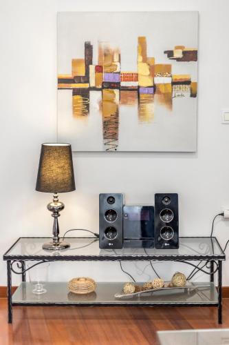 a table with a lamp and a radio on it at Apartments and Rooms Villa Erede in Split