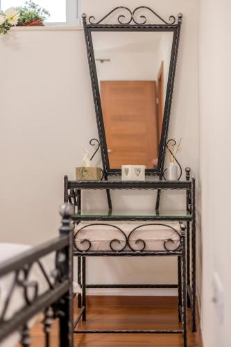 a black mirror on a shelf in a room at Apartments and Rooms Villa Erede in Split