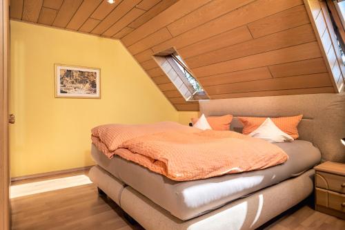 a bedroom with a bed in the corner of a room at Regenbogen-Appartement in Bad Krozingen