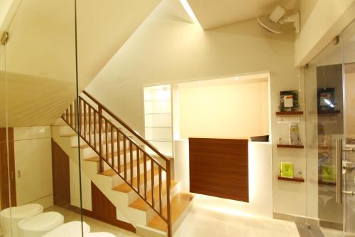 a staircase in a house with a glass wall at Castilo Inn Hotel Apartments in Cochin