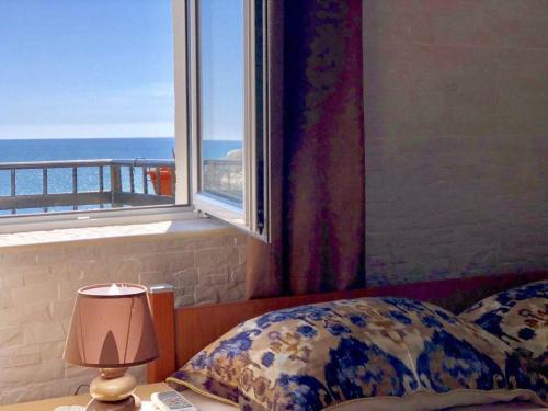a bedroom with a window with a view of the ocean at Apartments Zuto in Ulcinj