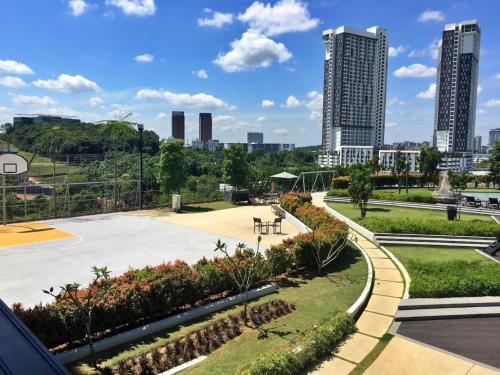 a park in a city with tall buildings at The ComfyHauz # Cyberjaya in Cyberjaya