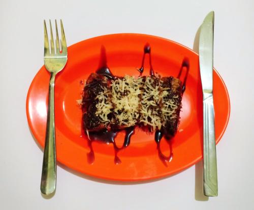 an orange plate with a piece of food on it at Dhika Adventure in Probolinggo