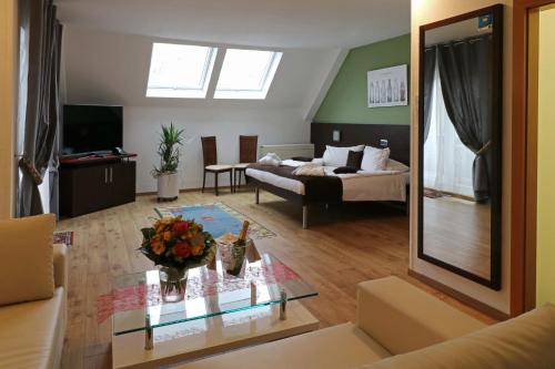 a living room with a couch and a table at Threeland Hotel in Pétange