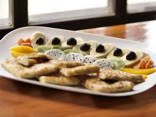 a plate of food with cookies and olives at Rondador Cotopaxi in Chasqui
