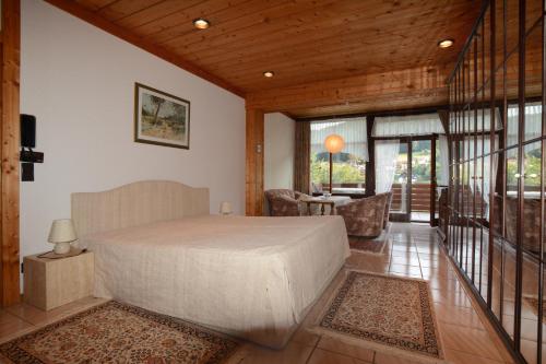 a bedroom with a bed and a living room at Haus Krick in Alpirsbach