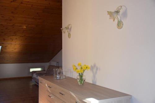 a vase of flowers on a table in a room at Appartamento Edoardo centro storico Cervia in Cervia