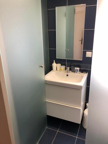 a bathroom with a sink and a mirror at AGION APOSTOLON 4 in Corfu Town