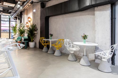 a group of tables and chairs in a room at 14 Reasons Why Hotel Athens in Athens