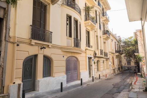 an empty street in a city with buildings at Wisdom Residence Luxury Apartments at Plaka in Athens