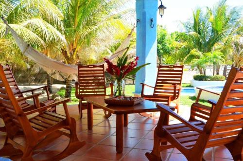 a patio with chairs and a table and a hammock at Solyar Luxury Spanish Beachfront Home in Pochomil