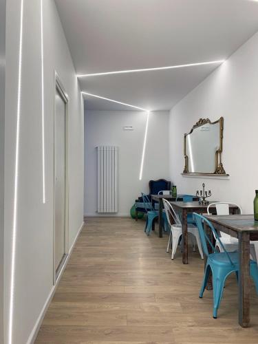 a dining room with tables and chairs and a mirror at Ai Tre Mercati in Palermo