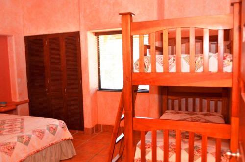 a bedroom with two bunk beds and a window at Solyar Luxury Spanish Beachfront Home in Pochomil