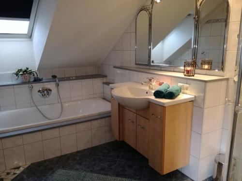 a bathroom with a sink and a bath tub at Ferienwohnung Sagmeister Wirtgut St. Andrä in Sankt Andrä im Lungau