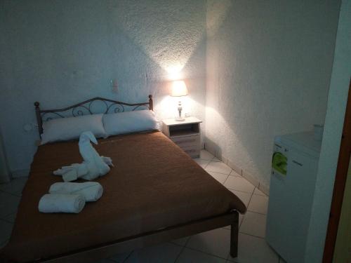 a bedroom with a bed with towels on it at Εmmi in Koutsounari