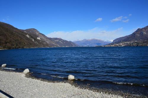 a large body of water with mountains in the background at Bellagio Love apartment Pool Near lake Free parking in Bellagio