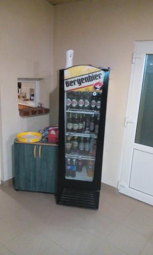 a refrigerator with a bunch of bottles of soda at Casa Cosmin in Dobra