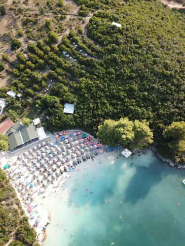 an aerial view of a beach with umbrellas and people at Delight Hotel in Ksamil
