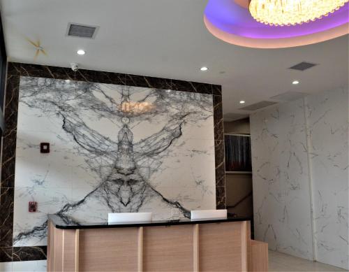 a wall mural in a hotel lobby with a drawing on it at LIC Plaza Hotel in Queens