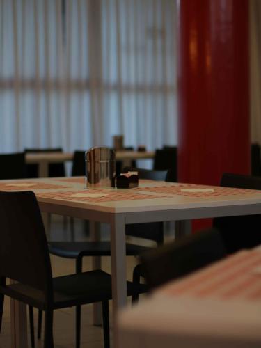 a table with a bucket sitting on top of it at Master Hotel Reggio Emilia in Reggio Emilia