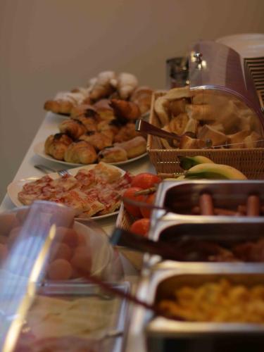 a table topped with lots of different types of food at Master Hotel Reggio Emilia in Reggio Emilia