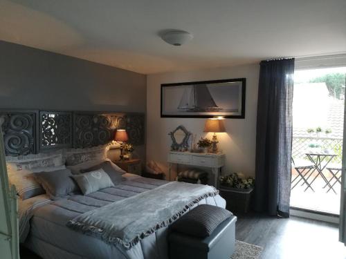 a bedroom with a bed and a tv on the wall at B&B Le Lanterne in Casal Palocco
