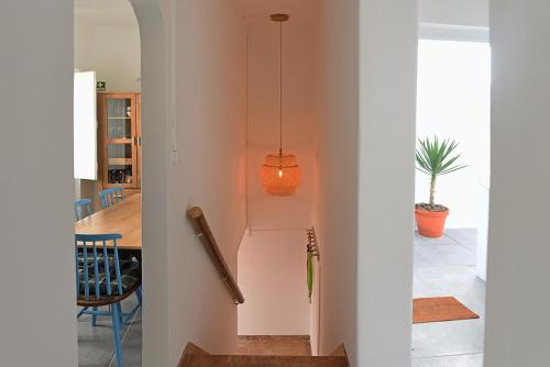 a hallway with an orange light hanging from a wall at Casa Castor Forno in Tavira