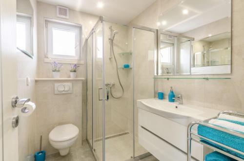 a bathroom with a shower and a toilet and a sink at KORČULA Antea Apartment in Prizba