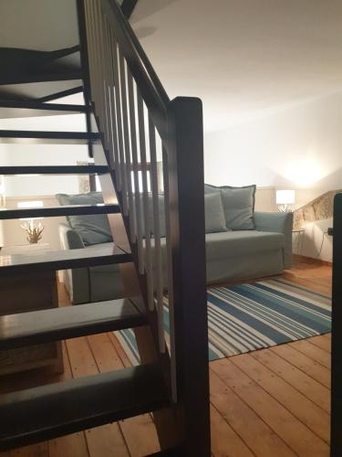 a staircase leading to a living room with a couch at Dimora Montalto,indipendente con terrazzo privato in Siracusa