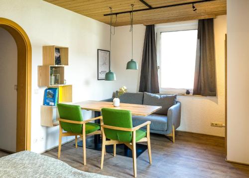 a dining room and living room with a table and chairs at Das Nordberg Guesthouse in Garmisch-Partenkirchen
