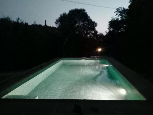 a swimming pool lit up at night at Olmedilla in Olmeda de las Fuentes