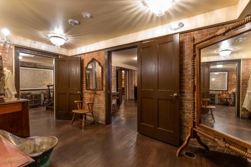 a room with a brick wall and a door at Steele Mansion Inn & Gathering Hub in Painesville