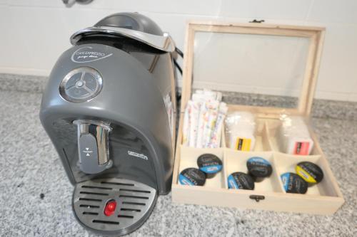 a gray mixer sitting on the floor next to a box at Férias no Bairro in Lisbon