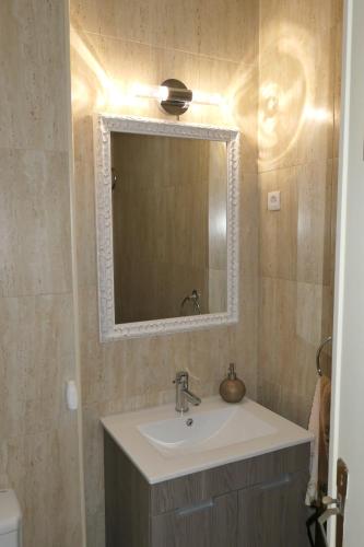 a bathroom with a sink and a mirror at Férias no Bairro in Lisbon