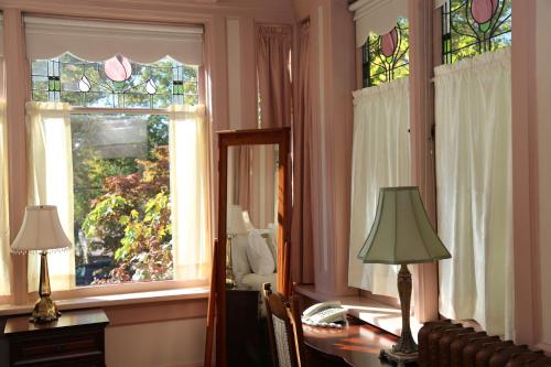 a room with a desk with a mirror and a window at Beaconsfield Bed and Breakfast - Victoria in Victoria