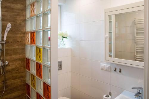 a bathroom with a sink and a mirror at Piaskowa Polana in Dębki