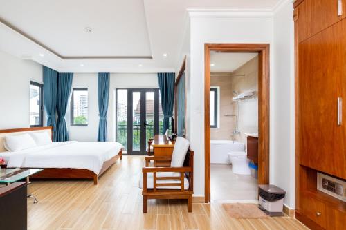 a hotel room with a bed and a bathroom at Sunny Hotel and Apartment in Ho Chi Minh City