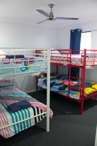 a room with two bunk beds and a ceiling at Family Friendly Holiday Home in Mackay